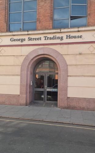 a building with an entrance to a garage street trading house at Lace Market Apartments - City Centre - 4 Beds Apartment with 2 Bathrooms and full Kitchen in George Street - close to Victoria Centre Shopping Centre - Parking for Cars & Vans from Five Pounds a Day - Sunday 1pm Check-out in Nottingham