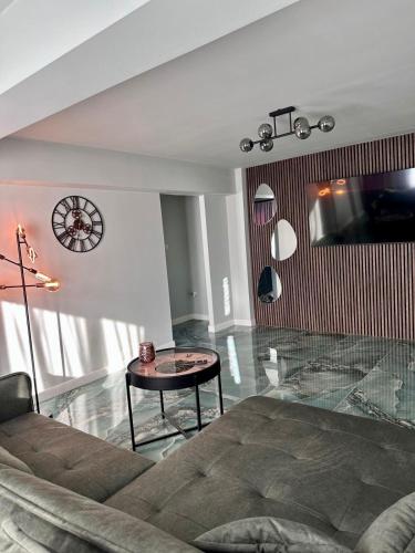 a living room with a couch and a table at GZP Residence Lugoj in Lugoj