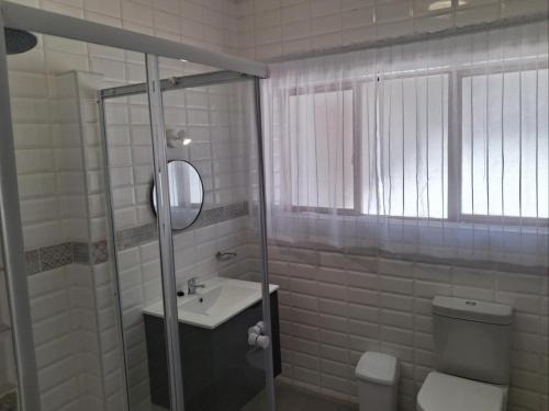 a bathroom with a toilet and a sink and a shower at Juliet Rose Luxury Guesthouse B&B in Bloemfontein