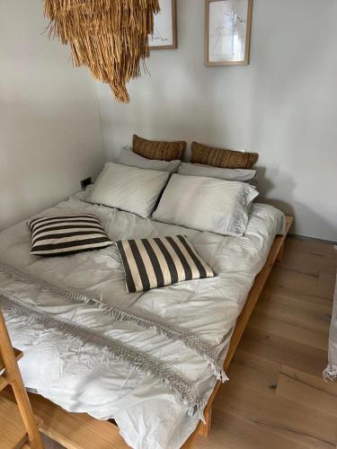 a large bed with white sheets and pillows on it at The best view in Marezige