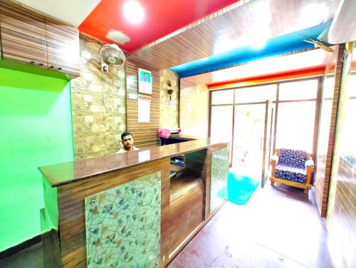 a man sitting at a bar in a room at Hotel Samrat Palace Puri-Odisha Near Sea-Beach With Free Wi-Fi and Parking Facility in Puri