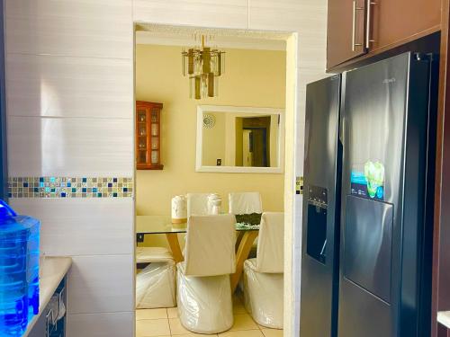 a kitchen with a table and a refrigerator at Inocova Fly in Kempton Park