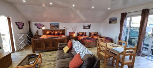 a living room with two beds and a couch at Windsor Cottage on The Big "W" Ranch in Nether Wasdale
