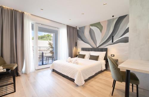 a bedroom with a bed and a large painting on the wall at Mediteran in Tučepi