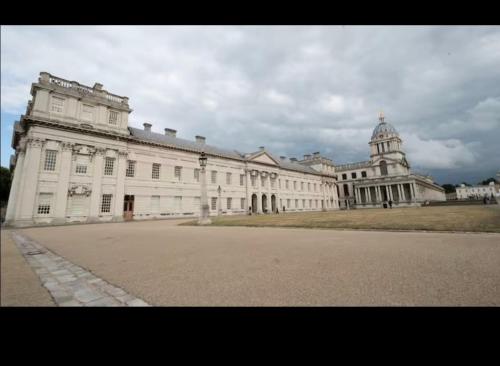 a large white building with a tower on top of it at Cosy 2 bed in the heart of Greenwich in London