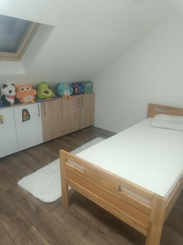 a bedroom with a bed and some stuffed animals at NiLa in Ivanjica