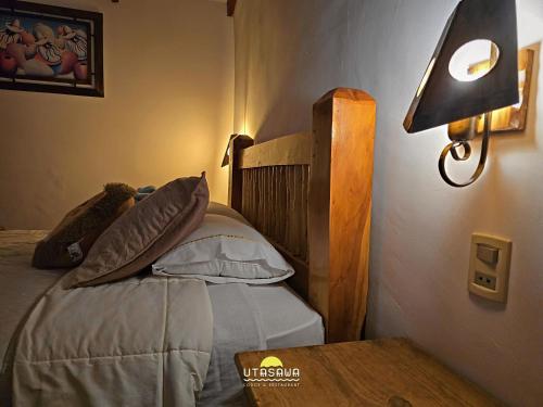 Een bed of bedden in een kamer bij Utasawa