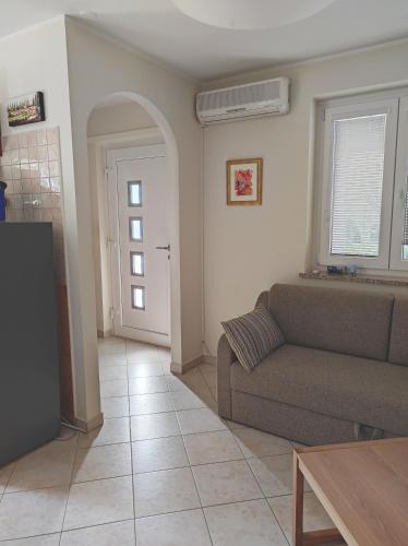 a living room with a couch and a table at Apartma Laura in Ankaran