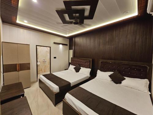 a hotel room with two beds in a room at Chhaya Niketan Home Stay in Ayodhya