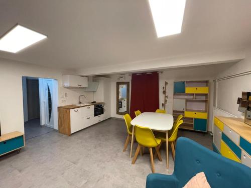 a kitchen and dining room with a table and chairs at Underground appart in Saint-Sébastien-sur-Loire