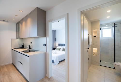 a kitchen with a sink and a bathroom with a bed at Mediteran in Tučepi