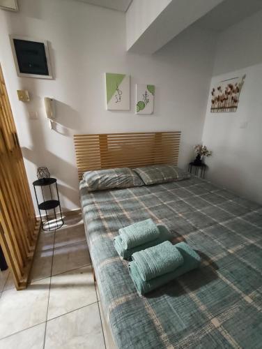 a bedroom with a large bed with two pillows on it at Blue Lagoon Studio in Missolonghi