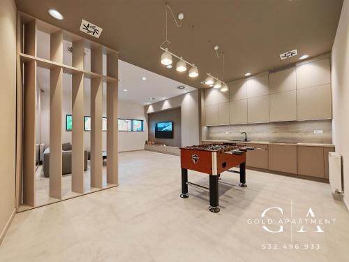 a room with a ping pong table in the middle at Gold Apartment E54 Let's Sea Baltic Park Gąski in Gąski