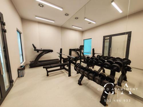 a gym with two rows of treadmills in a room at Gold Apartment E54 Let's Sea Baltic Park Gąski in Gąski