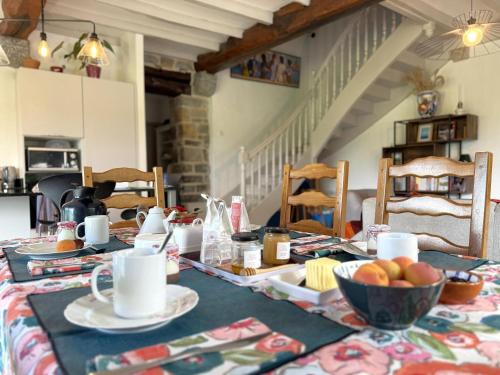 a dining table with a bowl of fruit on it at La Ferme d'Alotz-Chambres d'hôtes-Bed and breakfast in Arcangues