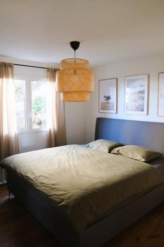 a bedroom with a large bed with a blue headboard at Ferienhaus Mostelrain in Sattel
