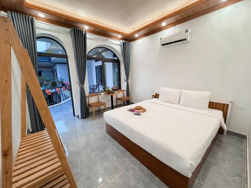 a bedroom with a bed and a table and chairs at Tuan Ngoc Hotel in Ninh Binh