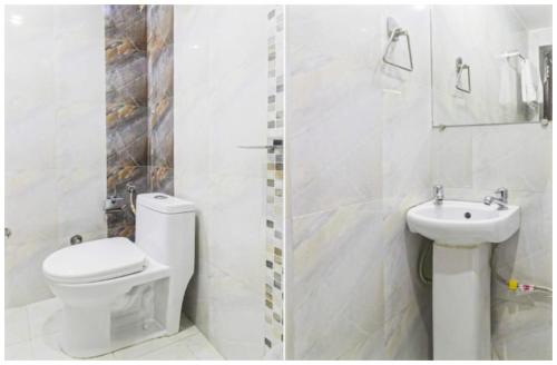 une salle de bain blanche avec toilettes et lavabo dans l'établissement Mountain Valley View Maya Hotel Near The Mall Road - Free Parking - Restaurant Facilities - Hygiene and Spacious Room - The Best Mountain Views Hotel In Mussoorie, à Mussoorie