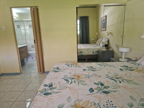 a bedroom with a bed with a floral bedspread at Seru Coral Resort Appartement 188 in Willemstad
