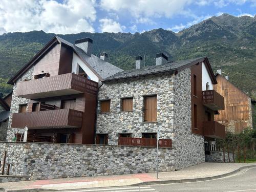 a stone building with balconies on the side of it at Tuca del Mont in Benasque
