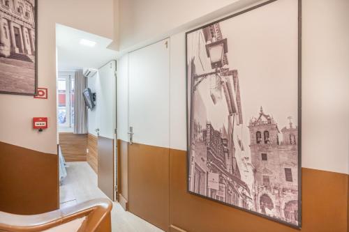 a hallway with a picture of a city on the wall at Souto Centro Rooms in Braga