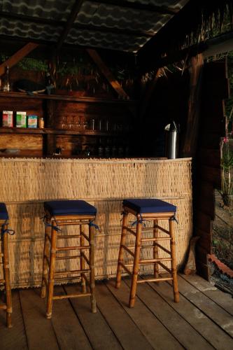 a pair of wooden stools sitting on a porch at Bubble Paradise, Koh ta Kiev in Koh Ta kiev Island