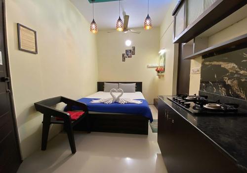 a small bedroom with a bed and a stove at Joys Stay in Trichūr