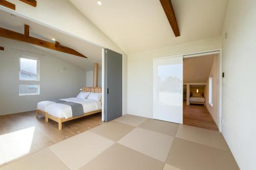 a bedroom with a bed in a room at The Lobs Toya, Chalet Secca in Lake Toya