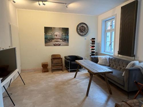 a living room with a couch and a table at Alte Poststation in Quedlinburg