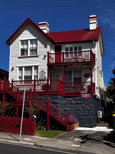 a large white house with a red roof at Mersey River Cottage ( cir 1888) Central location with Amazing Ocean and Habour Views. in Devonport