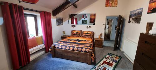 a bedroom with a bed and a window at The Big "W" Ranch House in Nether Wasdale