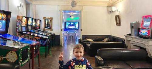 a young boy in a room with arcade games at Château de Seurre in Seurre