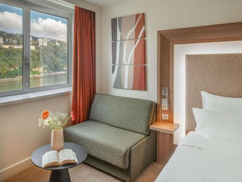 Ένα ή περισσότερα κρεβάτια σε δωμάτιο στο Novotel Lyon Centre-Confluence Bord de Saone