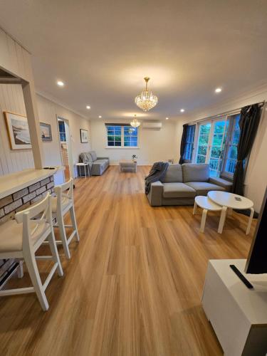 a living room with a couch and a table at The Greenview Luxe Home - Hornsby in Hornsby