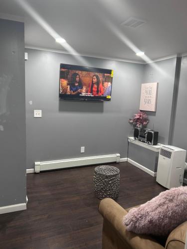 a living room with a flat screen tv on the wall at My lil doll house in Elizabeth
