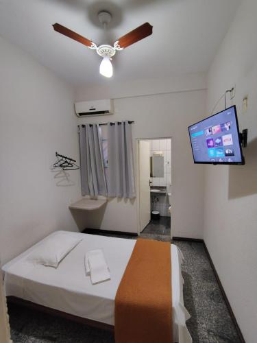 a bedroom with a bed and a flat screen tv at BIGS HOTEL in Penápolis