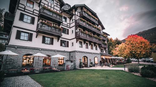 a large building with a lawn in front of it at Savoy Loft Apartment in Špindlerův Mlýn