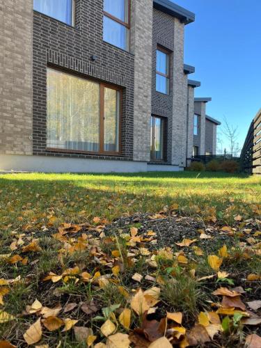 a house with autumn leaves in front of it at Baltašiške in Druskininkai