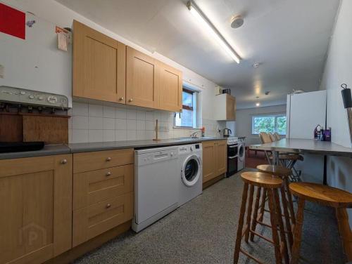 a kitchen with a washer and dryer in it at Private Room in Eglantine Avenue in Central Belfast in Belfast
