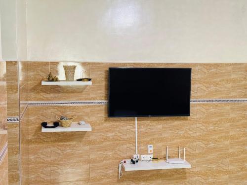 a flat screen tv hanging on a wall at Cozy & Chic Agadir Netflix, Beach & Comfort in Agadir