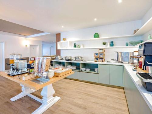 Una cocina con una mesa con algunos artículos encima. en Mercure Cairns, en Cairns