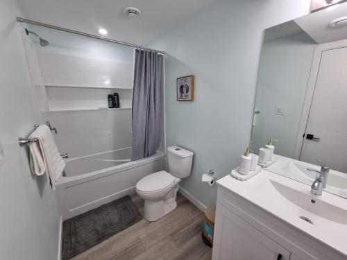 Un baño con bañera, inodoro y lavabo. en Kelvista's suite, en Winnipeg