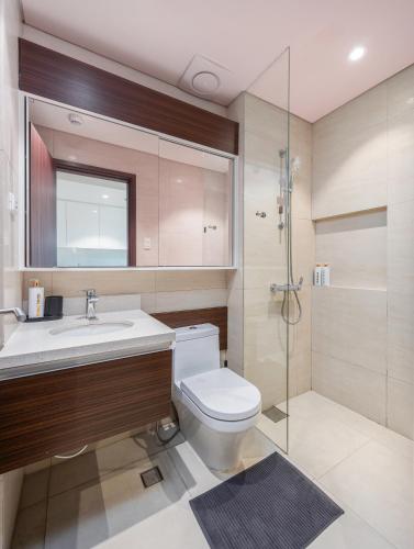 a bathroom with a toilet and a sink and a shower at Jungle Studio at Tambuli Ocean View by Dominik Studio with Pool & Balcony in Mactan in Lapu Lapu City