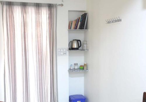 a corner of a room with a window and shelves at Pink City Heritage Homestay in Jaipur