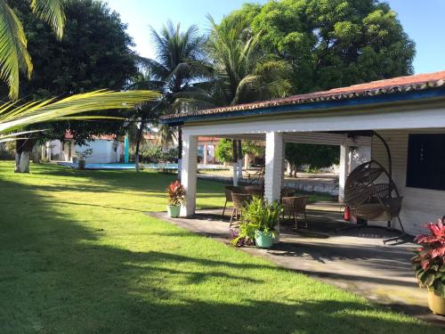 a porch of a house with a grass yard at Sitio Damiana in Paracuru