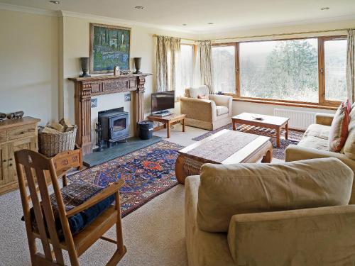 a living room with a couch and a fireplace at Rosmuire in Rhu