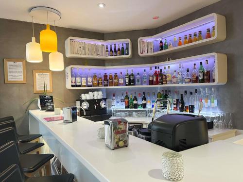 a bar with a counter with bottles on the wall at ibis Styles Paris Tolbiac Bibliotheque in Paris