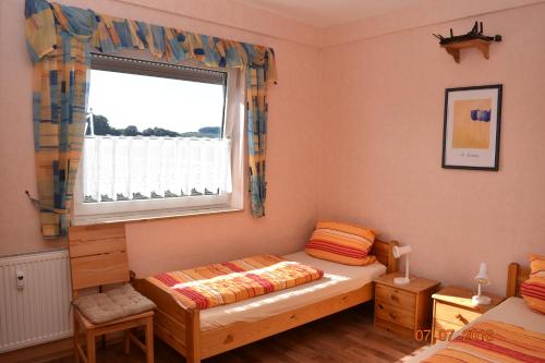 a bedroom with a bed and a window at Ferienweingut Borens in Wiltingen
