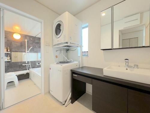 a white kitchen with a sink and a refrigerator at Grandioso Onna 7-D - Vacation STAY 10524v in Atsutabaru