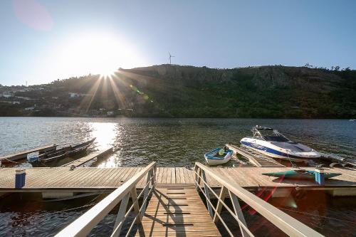 a boat is docked at a dock on a lake at Refúgio entre o Pomar e o Rio Douro in Raiva